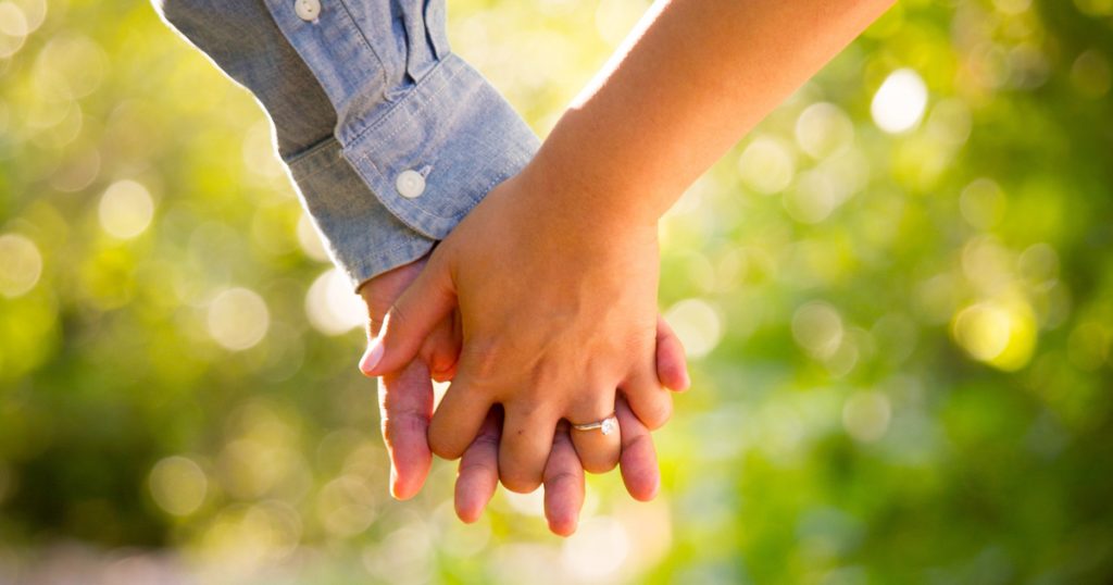 two people holding hands