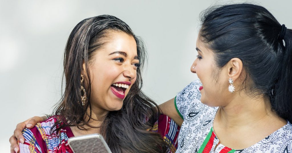 two friends chatting and laughing